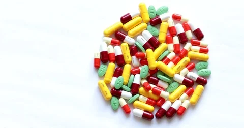 Breaking the round shape of medicine capsules and pills Stock Footage 72724423