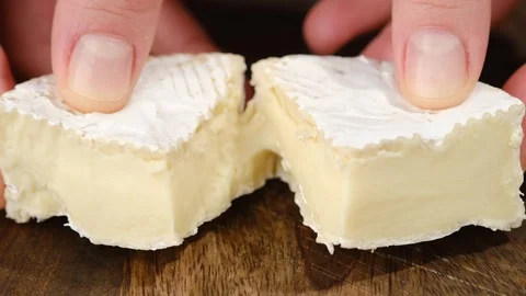 Breaking soft cheese camembert or brie in the hands Stock-Footage 129078618