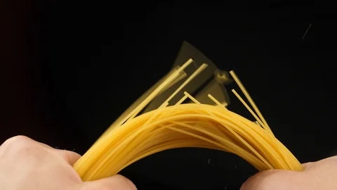 Breaking spaghetti on black background Closeup Slow motion video Stock Footage 111210321