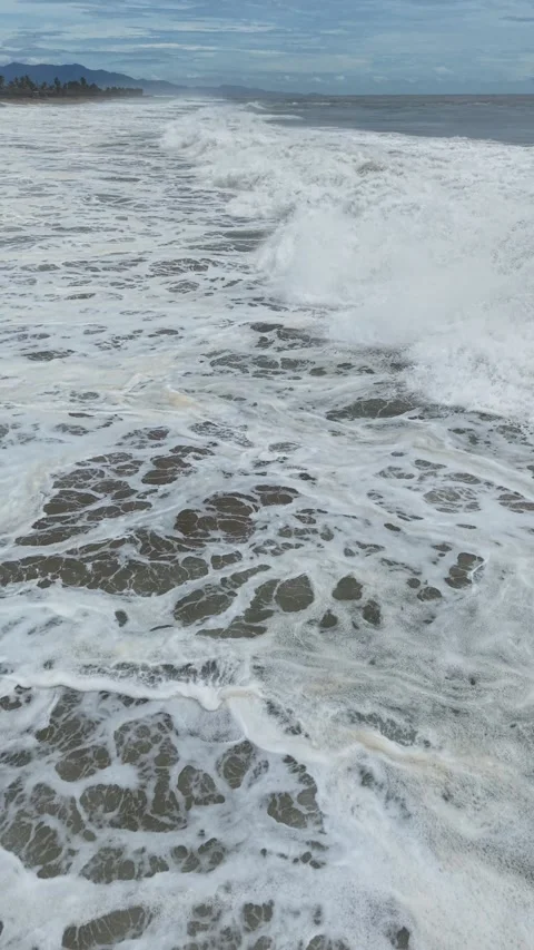 Breaking storm wave and churning foam, vertical aerial, near Acapulco Stock Footage 348301064
