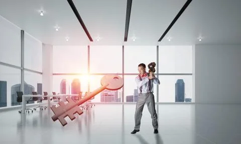 Breaking through access concept with furious man crashing concrete key Stock Photos