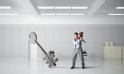 Breaking through access concept with furious man crashing concrete key Stock Photos