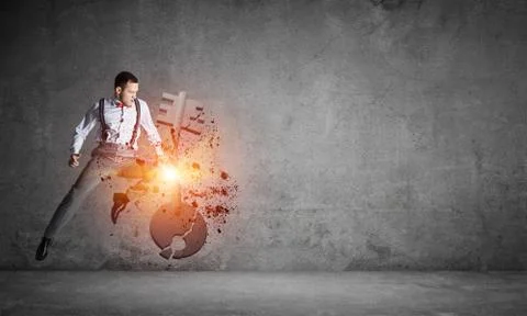 Breaking through access concept with furious man in room crashing concrete key 스톡 사진