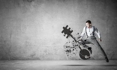 Breaking through access concept with furious man in room crashing concrete key 스톡 사진