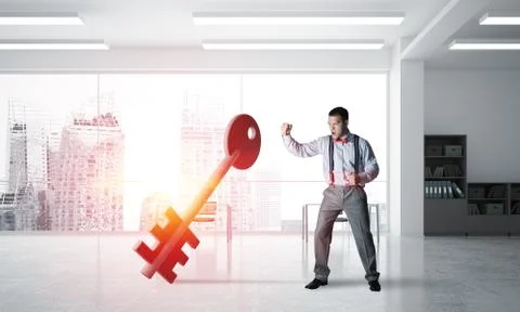 Breaking through access concept with furious man crashing concrete key Stock Photos