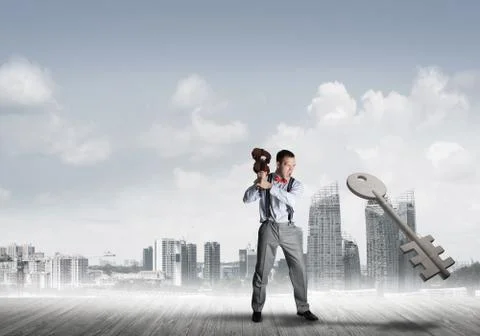 Breaking through access concept with furious man crashing concrete key Stock Photos