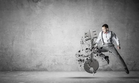 Breaking through access concept with furious man in room crashing concrete key 스톡 사진