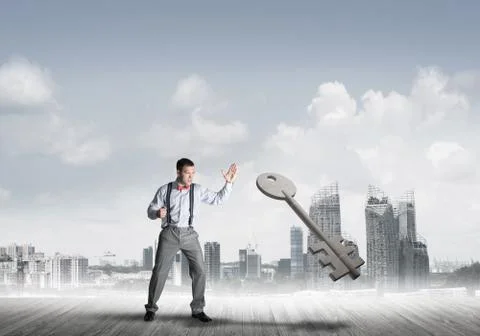 Breaking through access concept with furious man crashing concrete key Stock Photos