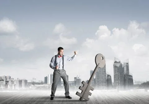 Breaking through access concept with furious man crashing concrete key 스톡 사진