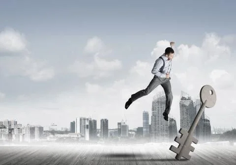 Breaking through access concept with furious man crashing concrete key 스톡 사진