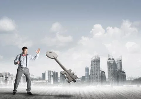 Breaking through access concept with furious man crashing concrete key Stock Photos