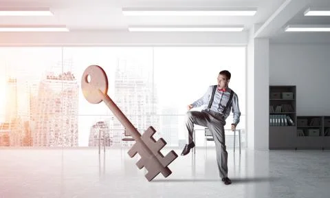Breaking through access concept with furious man crashing concrete key Stock Photos