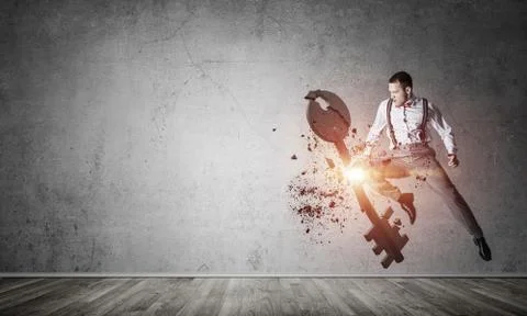 Breaking through access concept with furious man in room crashing concrete key 스톡 사진