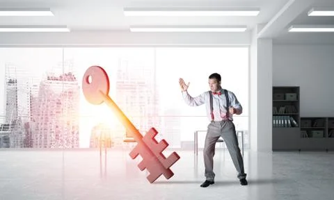 Breaking through access concept with furious man crashing concrete key Stock Photos