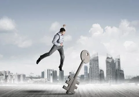 Breaking through access concept with furious man crashing concrete key 스톡 사진