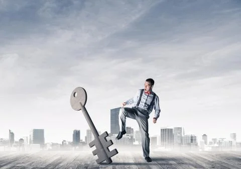 Breaking through access concept with furious man crashing concrete key Stock Photos