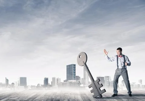 Breaking through access concept with furious man crashing concrete key 스톡 사진