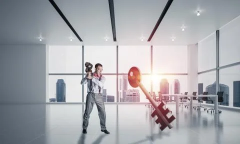 Breaking through access concept with furious man crashing concrete key 스톡 사진