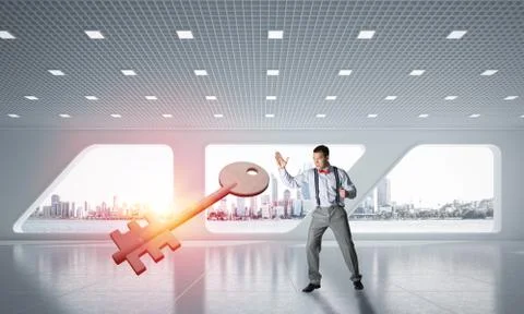 Breaking through access concept with furious man crashing concrete key 스톡 사진