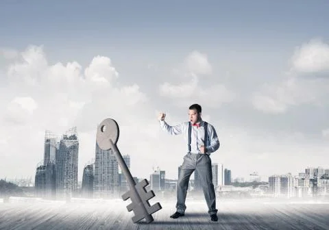 Breaking through access concept with furious man crashing concrete key Stock Photos