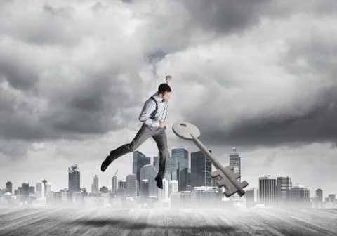 Breaking through access concept with furious man crashing concrete key 스톡 사진