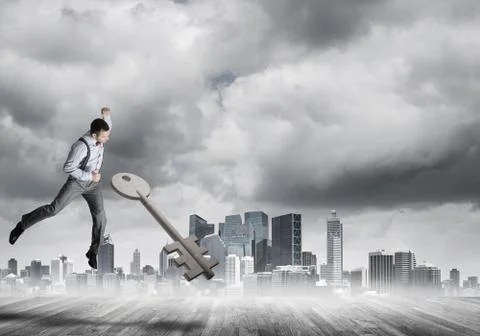 Breaking through access concept with furious man crashing concrete key Stock Photos