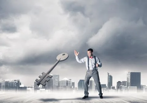 Breaking through access concept with furious man crashing concrete key Stock Photos