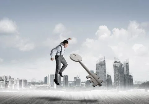 Breaking through access concept with furious man crashing concrete key Stock Photos