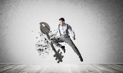 Breaking through access concept with furious man in room crashing concrete key Stock Photos