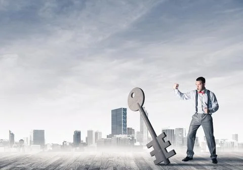 Breaking through access concept with furious man crashing concrete key Stock Photos