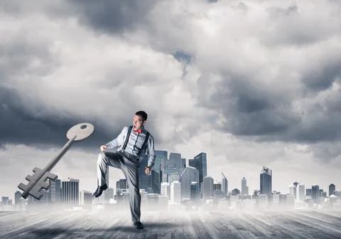 Breaking through access concept with furious man crashing concrete key Stock Photos