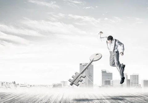 Breaking through access concept with furious man crashing concrete key 스톡 사진