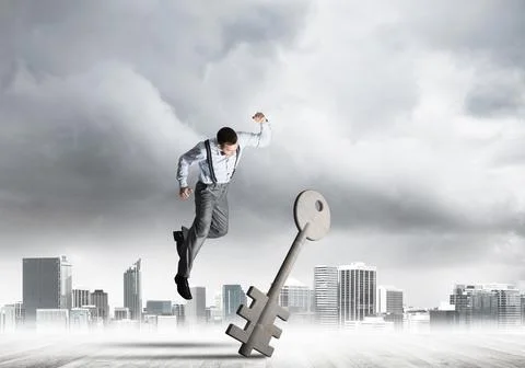 Breaking through access concept with furious man crashing concrete key 스톡 사진
