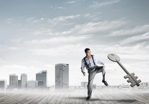 Breaking through access concept with furious man crashing concrete key Stock Photos