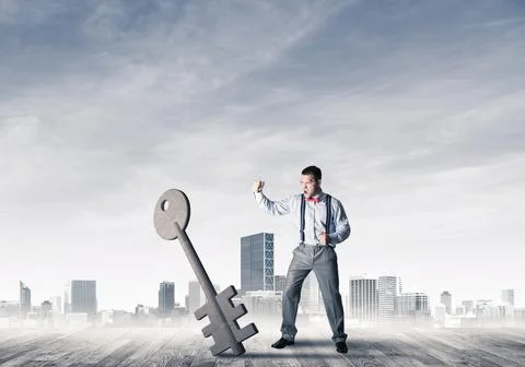 Breaking through access concept with furious man crashing concrete key 写真素材