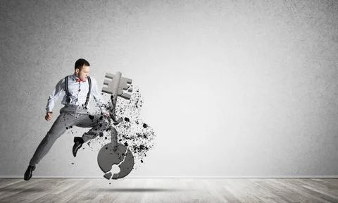 Breaking through access concept with furious man in room crashing concrete... Stock Photos
