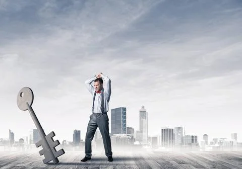 Breaking through access concept with furious man crashing concrete key Det... 스톡 사진