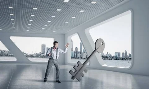 Breaking through access concept with furious man crashing concrete key Det... 스톡 사진