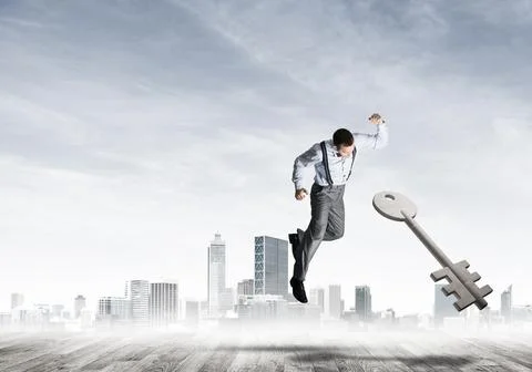 Breaking through access concept with furious man crashing concrete key 스톡 사진