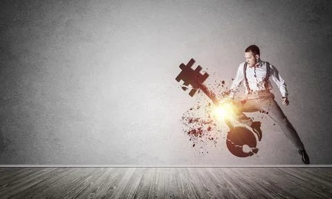 Breaking through access concept with furious man in room crashing concrete key 스톡 사진