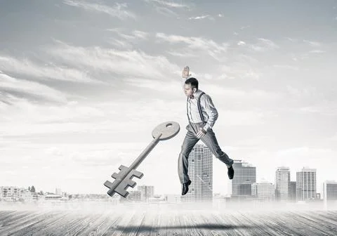 Breaking through access concept with furious man crashing concrete key Stock Photos
