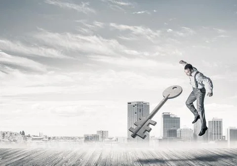 Breaking through access concept with furious man crashing concrete key Stock Photos