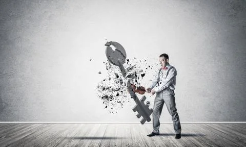 Breaking through access concept with man in room crashing concre Stock Photos