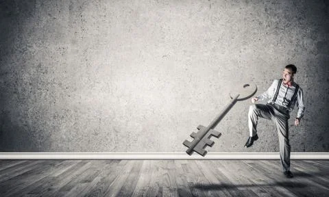 Breaking through access concept with man in room crashing concre 스톡 사진