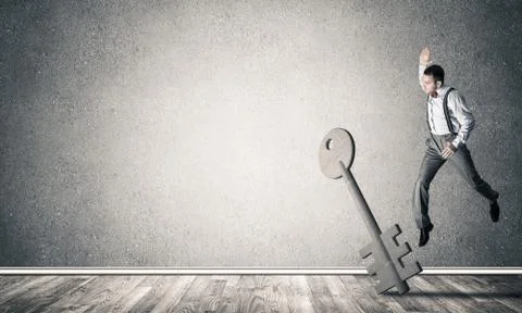 Breaking through access concept with man in room crashing concre 스톡 사진