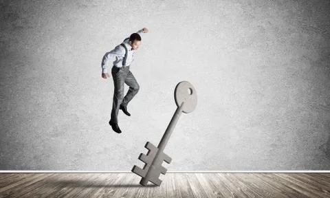 Breaking through access concept with man in room crashing concrete key Stock Photos