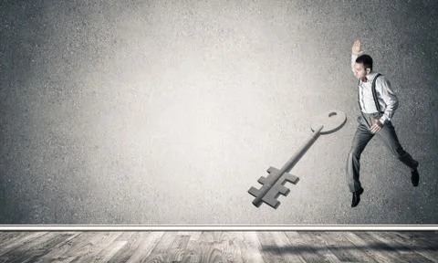 Breaking through access concept with man in room crashing concre Stock Photos