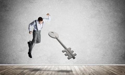 Breaking through access concept with man in room crashing concrete key Stock Photos