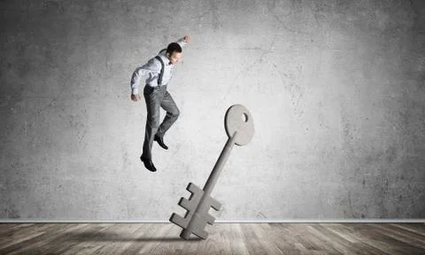 Breaking through access concept with man in room crashing concrete key Stock Photos