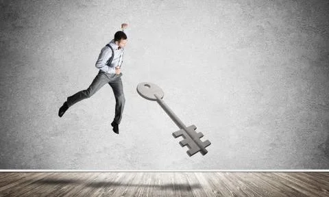 Breaking through access concept with man in room crashing concrete key Stock Photos